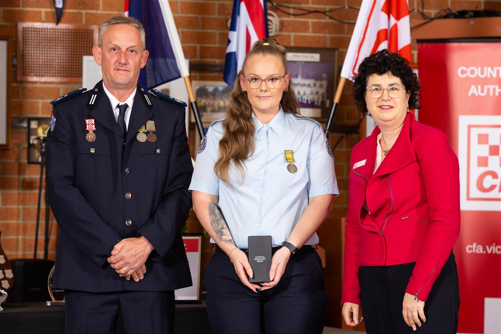 Firefighter Hayley Hanson (centre) received the National Emergency Medal for the 2019/20 Bushfires, pictured with A/Commander Paul Brislin & Interim CEO Robyn Harris