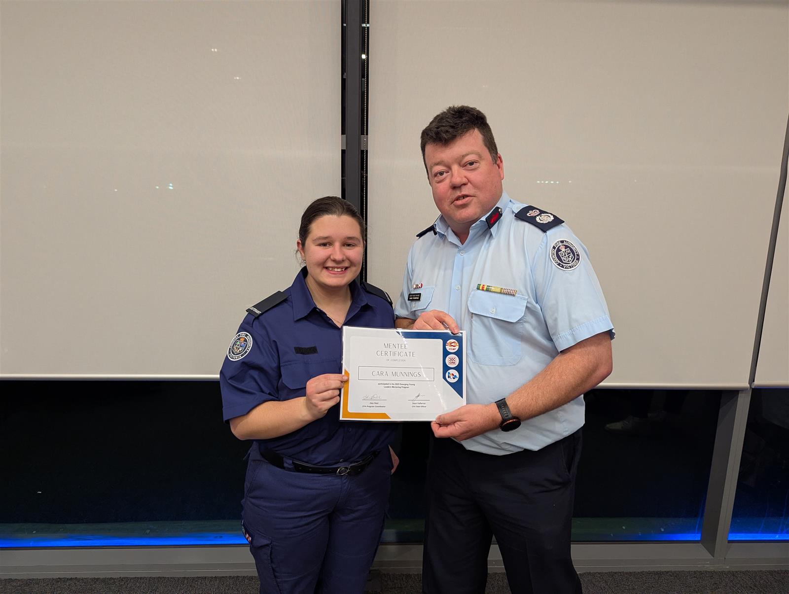 Mentee Cara Munnings receives her acknowledgement certificate from DCO Gavin Thompson