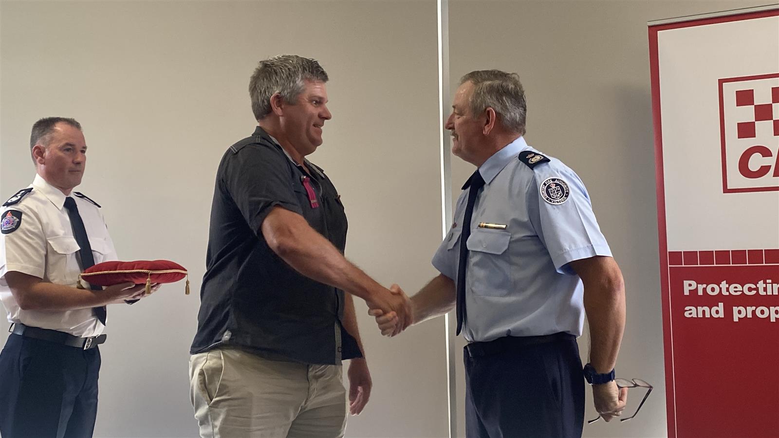 Bradley Burke receives his commendation from DCO Bill Johnstone